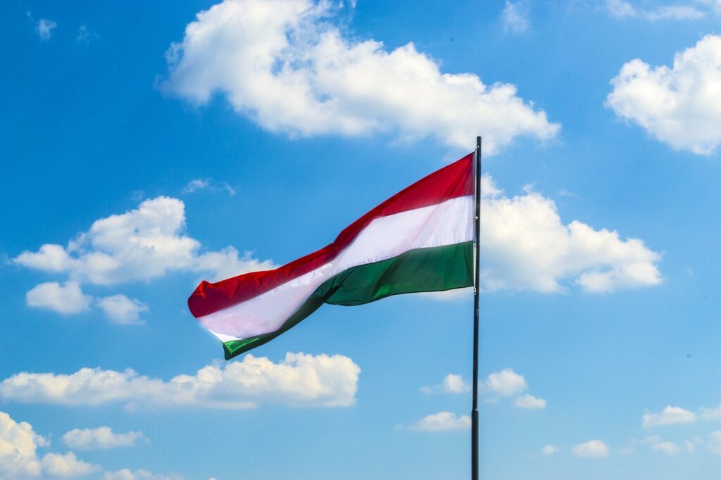 Image of a Hungarian flag waving among clouds