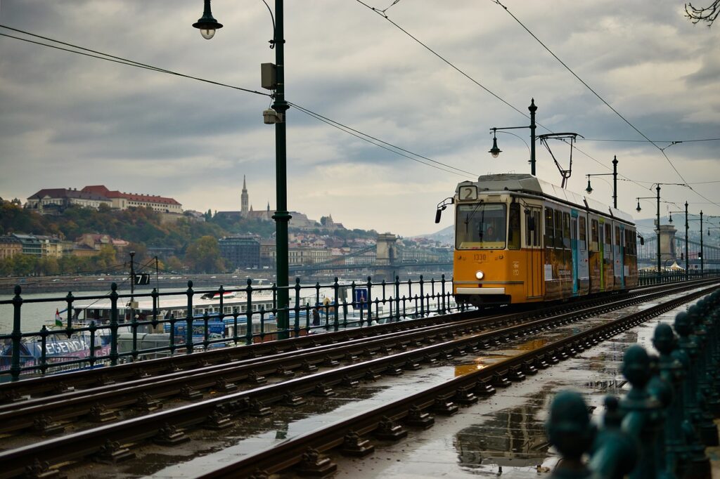 Image of a tram passing by next to the Danube river in Budapest