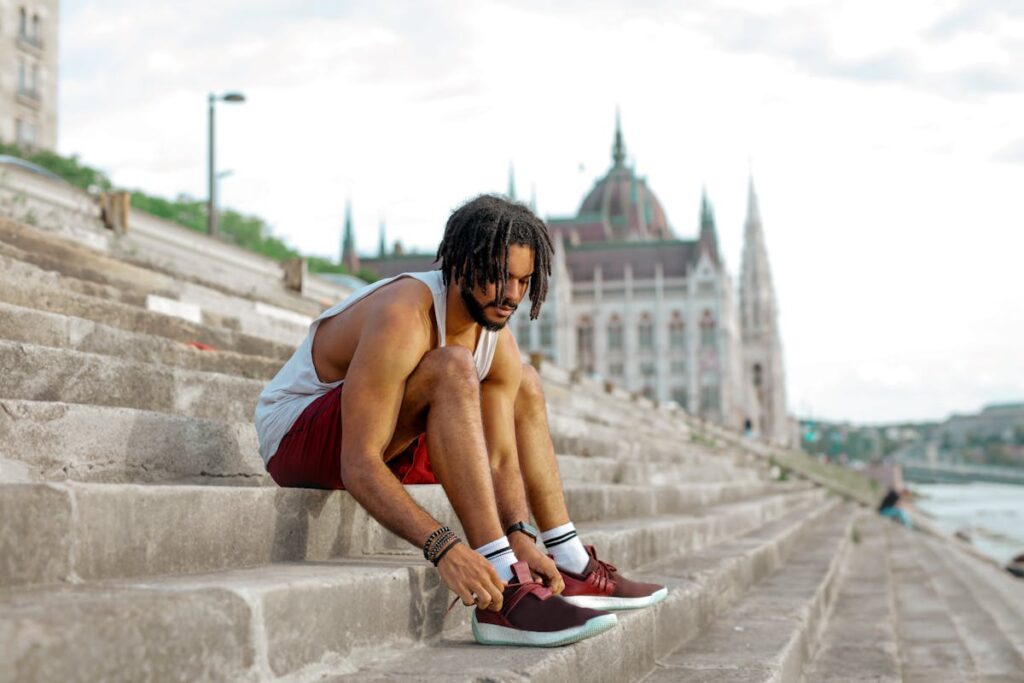 An expat lacing his shoes in front of the Hungarian Parliament in Budapest.
