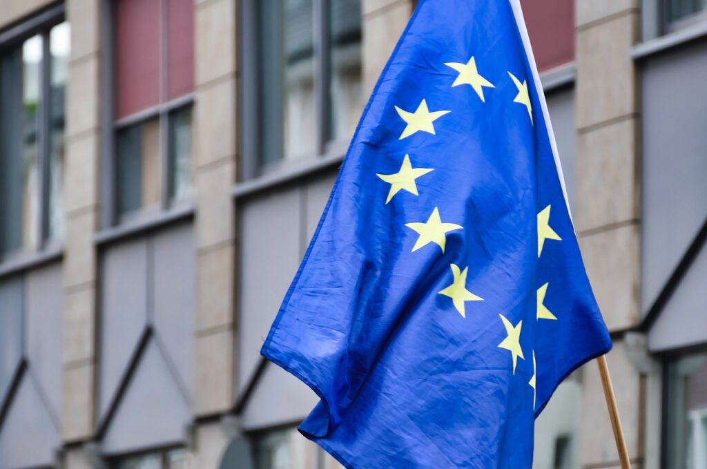 An image of the flag of the European Union hanging from an old building's facade