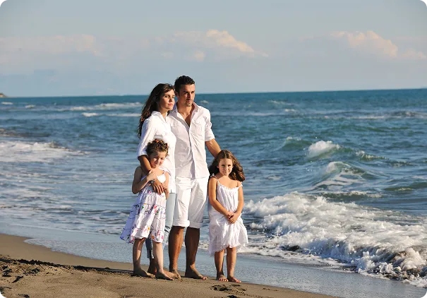 Family on a beach in Europe weighing their residency options
