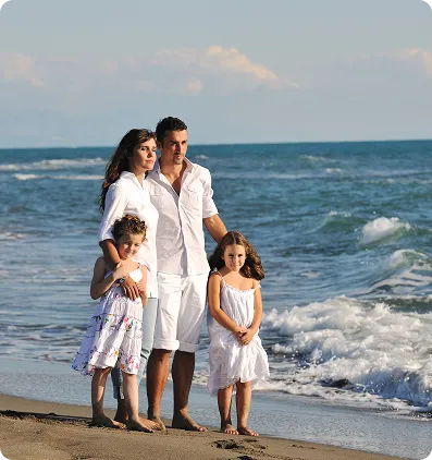 Family walking on a beach after relocating to Europe