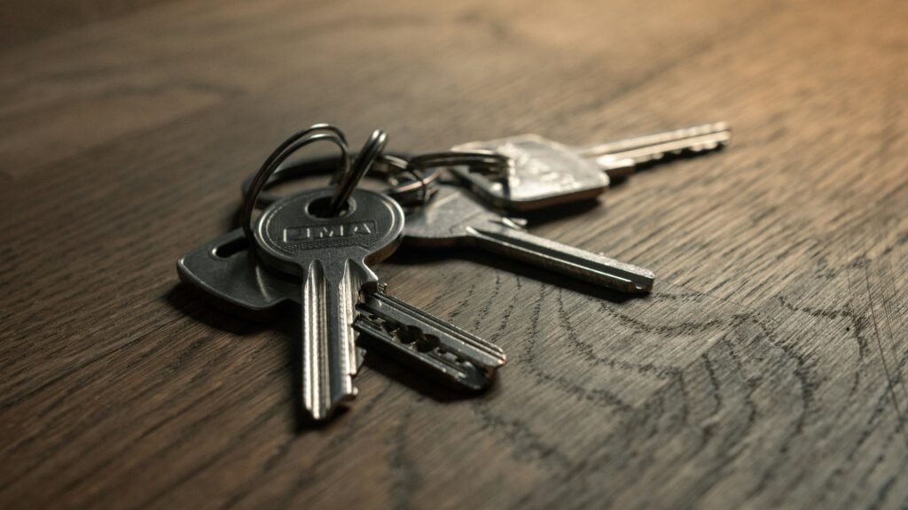 A set of house keys on a wooden table, the symbol of residency by investment as distinct from citizenship by investment